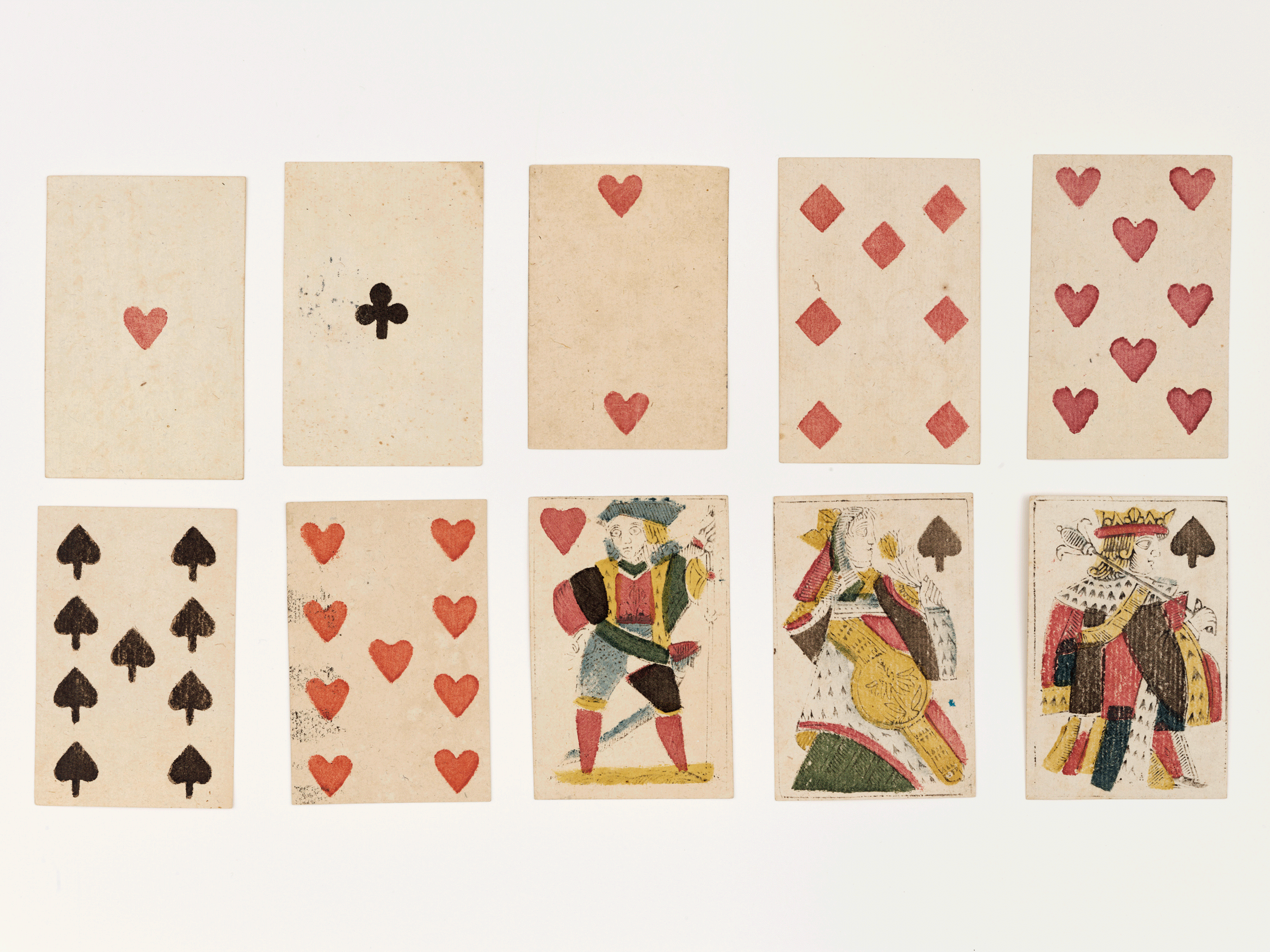 Jeu de cartes ancien avec des trèfles, des carreaux, des cœurs et des piques.